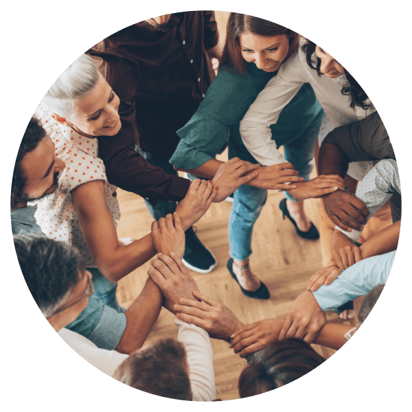 people holding hands in a circle